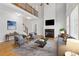 Bright living room with fireplace, hardwood floors, and large windows providing natural light at 2620 Bent Creek Dr, Cumming, GA 30041