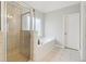 Main bathroom with a glass shower and soaking tub at 2620 Bent Creek Dr, Cumming, GA 30041
