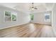 Spacious empty bedroom with tray ceiling, ceiling fan, and large windows at 2620 Bent Creek Dr, Cumming, GA 30041