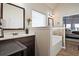 Bright bathroom showing a dark wood vanity, white countertop, separate tub, and glass shower in background at 3877 Valley Bluff Ln, Snellville, GA 30039