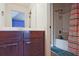 Bathroom showcasing a wood vanity with a white countertop and separate tub/shower with shower curtain at 3877 Valley Bluff Ln, Snellville, GA 30039