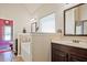 Bright bathroom features a dark wood vanity with white countertop, separate tub, and lots of natural light at 3877 Valley Bluff Ln, Snellville, GA 30039