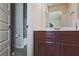Bathroom featuring a dark wood vanity and white countertop with a separate tub/shower in the background at 3877 Valley Bluff Ln, Snellville, GA 30039