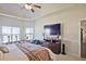 Bright Primary bedroom with large windows, modern furniture, and a ceiling fan at 3877 Valley Bluff Ln, Snellville, GA 30039
