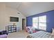 Comfortable bedroom featuring neutral walls, a large window, and blue decor at 3877 Valley Bluff Ln, Snellville, GA 30039