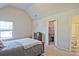 Neutral bedroom features a window for natural light and access to a walk-in closet and bathroom at 3877 Valley Bluff Ln, Snellville, GA 30039