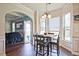 Bright breakfast area with many windows, dark hardwood floors, and a view into the kitchen at 3877 Valley Bluff Ln, Snellville, GA 30039