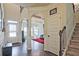 Grand foyer featuring hardwood floors, arched doorways, and a staircase leading to the upper level at 3877 Valley Bluff Ln, Snellville, GA 30039