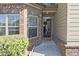 Inviting entryway with a brick facade, a 'hello' mat, and natural light streaming through the windows at 3877 Valley Bluff Ln, Snellville, GA 30039
