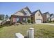 A picturesque view of a beautifully landscaped front yard with green grass and lovely shrubs at 3877 Valley Bluff Ln, Snellville, GA 30039