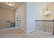 Upstairs hallway featuring neutral walls and a staircase with a chandelier overhead at 3877 Valley Bluff Ln, Snellville, GA 30039