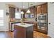 Modern kitchen featuring a center island, granite countertops, and stainless steel appliances for culinary enthusiasts at 3877 Valley Bluff Ln, Snellville, GA 30039