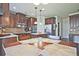 A spacious kitchen offering wooden cabinetry, granite countertops, stainless steel appliances and central island at 3877 Valley Bluff Ln, Snellville, GA 30039