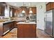 A functional kitchen offers wooden cabinetry, granite countertops, stainless steel appliances, and central island at 3877 Valley Bluff Ln, Snellville, GA 30039