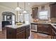 A spacious kitchen offering wooden cabinetry, granite countertops, stainless steel appliances and central island at 3877 Valley Bluff Ln, Snellville, GA 30039