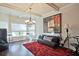 Elegant living room showcasing hardwood floors, neutral paint, and a decorative chandelier and modern decor at 3877 Valley Bluff Ln, Snellville, GA 30039