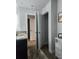 Bathroom featuring double sinks, granite countertops, tile floors, and access to closet storage at 4833 Station Lane -Lot 28, Union City, GA 30349