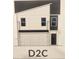 Modern two-story home exterior featuring attached two-car garage and minimalist design at 4833 Station Lane -Lot 28, Union City, GA 30349