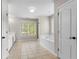 Bright bathroom featuring a soaking tub and a separate shower at 5106 Davis Love Dr, Cumming, GA 30041