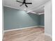 This bedroom offers ample space with modern ceiling fan and wood flooring at 5106 Davis Love Dr, Cumming, GA 30041