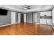 Spacious bedroom with hardwood floors, ceiling fan, and a wet bar at 5106 Davis Love Dr, Cumming, GA 30041