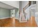 Open entryway showcases gorgeous hardwood floors, staircase with wooden rails, and access to multiple rooms at 5106 Davis Love Dr, Cumming, GA 30041