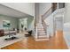 Bright entryway offers gorgeous hardwood floors, a staircase with wooden rails, and open access to the living room at 5106 Davis Love Dr, Cumming, GA 30041