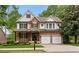 Charming two-story home with stone accents, well-manicured lawn, and a two-car garage at 5106 Davis Love Dr, Cumming, GA 30041