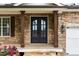 Inviting entryway showcasing double front doors, stone facade and covered porch at 5106 Davis Love Dr, Cumming, GA 30041