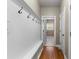 Hallway with coat hooks and storage bench leading to a laundry room at 5106 Davis Love Dr, Cumming, GA 30041