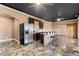 This kitchenette offers stainless steel appliances, bar seating, and modern countertops at 5106 Davis Love Dr, Cumming, GA 30041