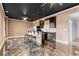 This kitchenette offers stainless steel appliances, bar seating, and modern countertops at 5106 Davis Love Dr, Cumming, GA 30041