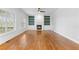 Bright living room featuring a fireplace, built-in shelving, hardwood floors, and plenty of natural light at 5106 Davis Love Dr, Cumming, GA 30041