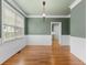 Bright living room featuring hardwood floors, wainscoting details and large windows for natural lighting at 5106 Davis Love Dr, Cumming, GA 30041