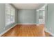Bright living room featuring hardwood floors, large windows and trimmed entryway columns for a luxurious feel at 5106 Davis Love Dr, Cumming, GA 30041