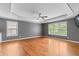 Spacious main bedroom with tray ceiling, hardwood floors, and large windows at 5106 Davis Love Dr, Cumming, GA 30041