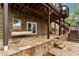 This outdoor patio features beautiful stonework, a hanging swing, and easy access to the backyard at 5106 Davis Love Dr, Cumming, GA 30041