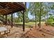 Enjoy outdoor living on this stone patio with golf course views and mature trees at 5106 Davis Love Dr, Cumming, GA 30041