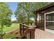 Enjoy panoramic golf course views from this screened porch with wood floors and comfortable seating at 5106 Davis Love Dr, Cumming, GA 30041