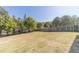 Expansive backyard featuring mature trees and a well-maintained lawn at 1542 Armende Cir, Dacula, GA 30019