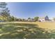 Spacious backyard with a lush lawn, mature trees, and a view of the house at 1542 Armende Cir, Dacula, GA 30019