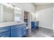 Bright bathroom featuring double vanity with blue cabinets and a sleek modern design at 1542 Armende Cir, Dacula, GA 30019