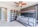 Carpeted bedroom features bunk beds, a bookcase, and a ceiling fan at 1542 Armende Cir, Dacula, GA 30019