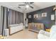 Bedroom featuring a crib, dresser, rocking chair and themed wall decor at 1542 Armende Cir, Dacula, GA 30019