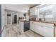 Bright kitchen with white cabinets, wood countertops and modern stainless steel dishwasher at 1542 Armende Cir, Dacula, GA 30019