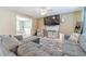 Cozy living room with a gray sectional sofa and view into dining area at 1542 Armende Cir, Dacula, GA 30019