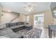 Spacious living room featuring a comfortable gray sectional sofa and bright natural light at 1542 Armende Cir, Dacula, GA 30019