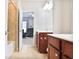Bathroom with double sinks and vanity, with a view of the baby's room with its whimsical wallpaper at 2248 Fort Se Dr, Smyrna, GA 30080