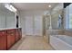 Bright bathroom featuring a soaking tub, glass enclosed shower, tile floors and double sink vanity at 2248 Fort Se Dr, Smyrna, GA 30080