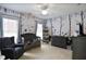 Bedroom room featuring playful wallpaper, a cozy crib, a comfy chair, and a ceiling fan at 2248 Fort Se Dr, Smyrna, GA 30080